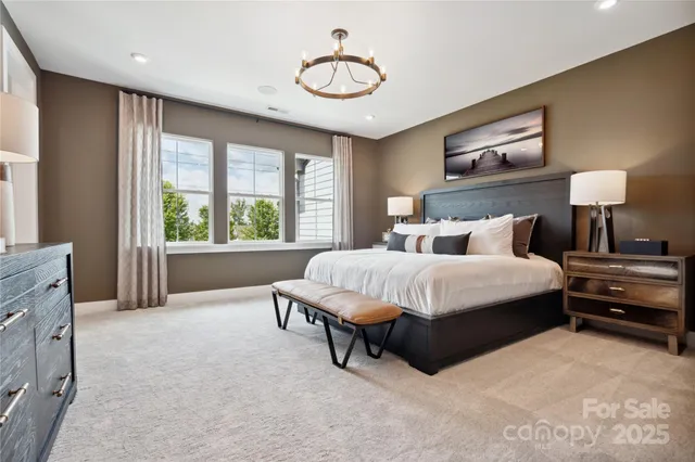 a spacious bedroom with a bed and window