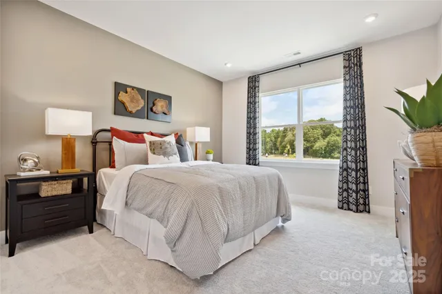 a bedroom with a bed and a night stand