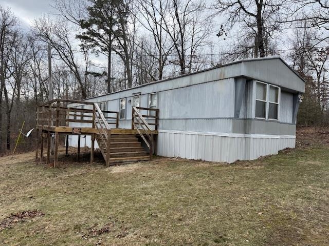 367 Eldie Foster Road Pocahontas, TN 38061 - Photo 2 of 14 Manufactured / mobile home featuring stairs, a front yard, and a deck