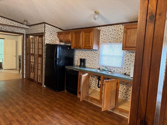 367 Eldie Foster Road Pocahontas, TN 38061 - Photo 6 of 14 Kitchen with black appliances, vaulted ceiling, brown cabinets, and wallpapered walls