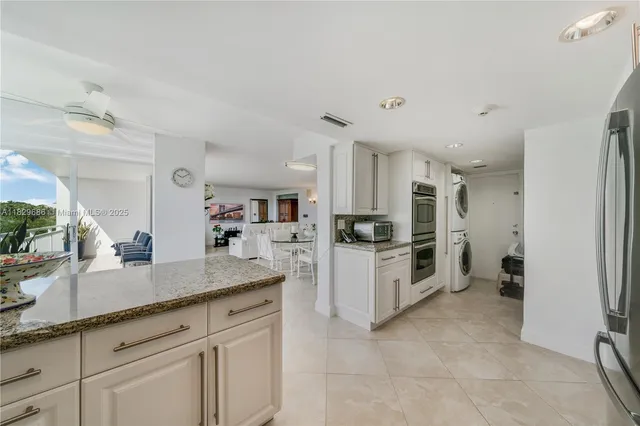 a kitchen with cabinets and a refrigerator