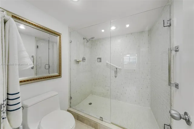 a bathroom with a shower a toilet and sink