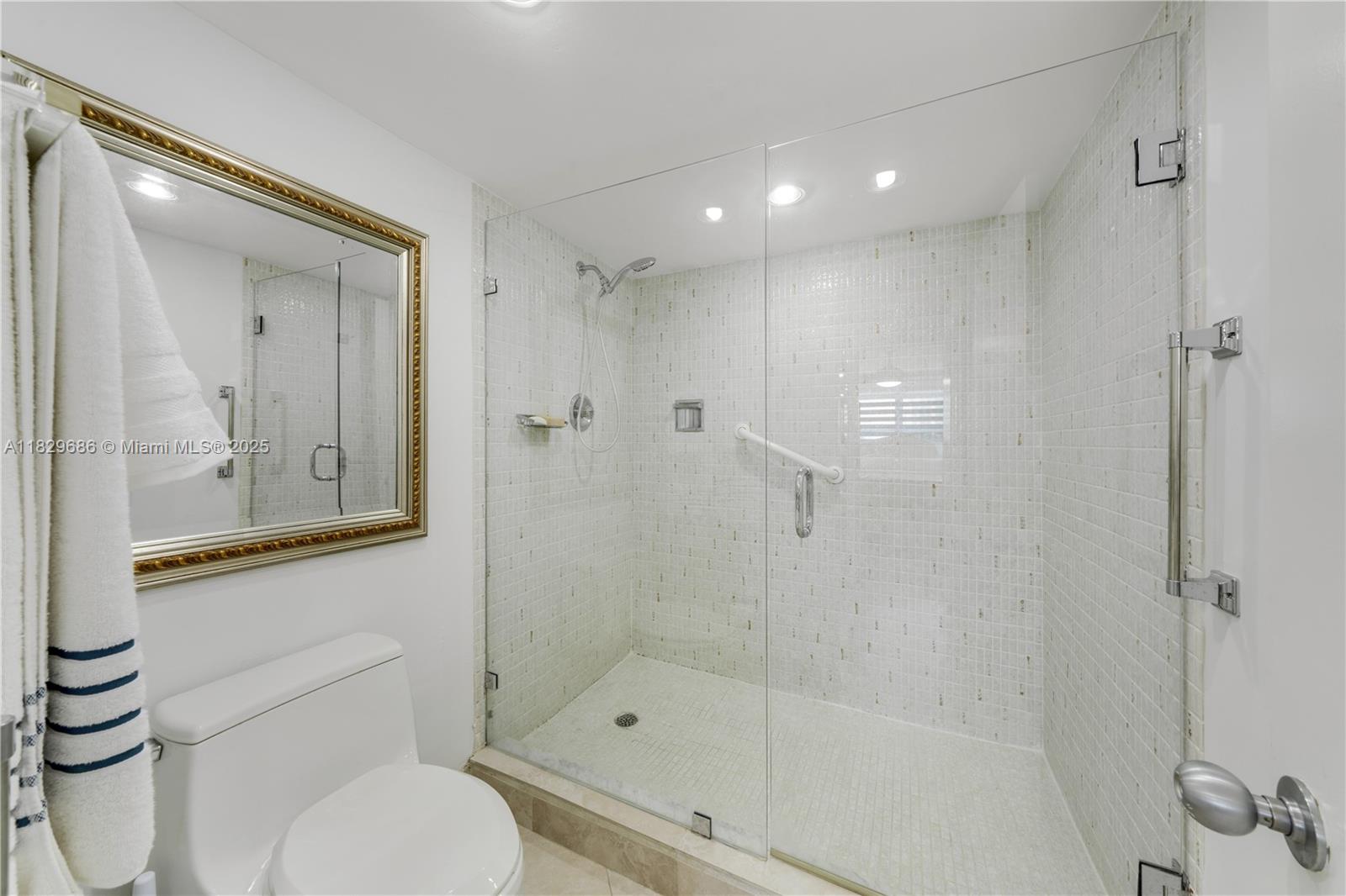 609 Ocean Drive, Unit 5H Key Biscayne, FL 33149 - Photo 18 of 28 a bathroom with a shower a toilet and sink