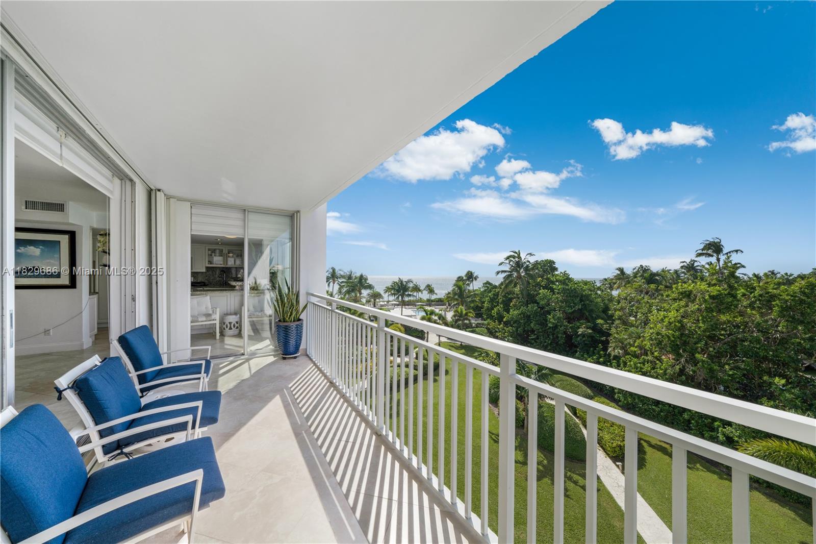 609 Ocean Drive, Unit 5H Key Biscayne, FL 33149 - Photo 2 of 28 a view of a chair and tables in the balcony