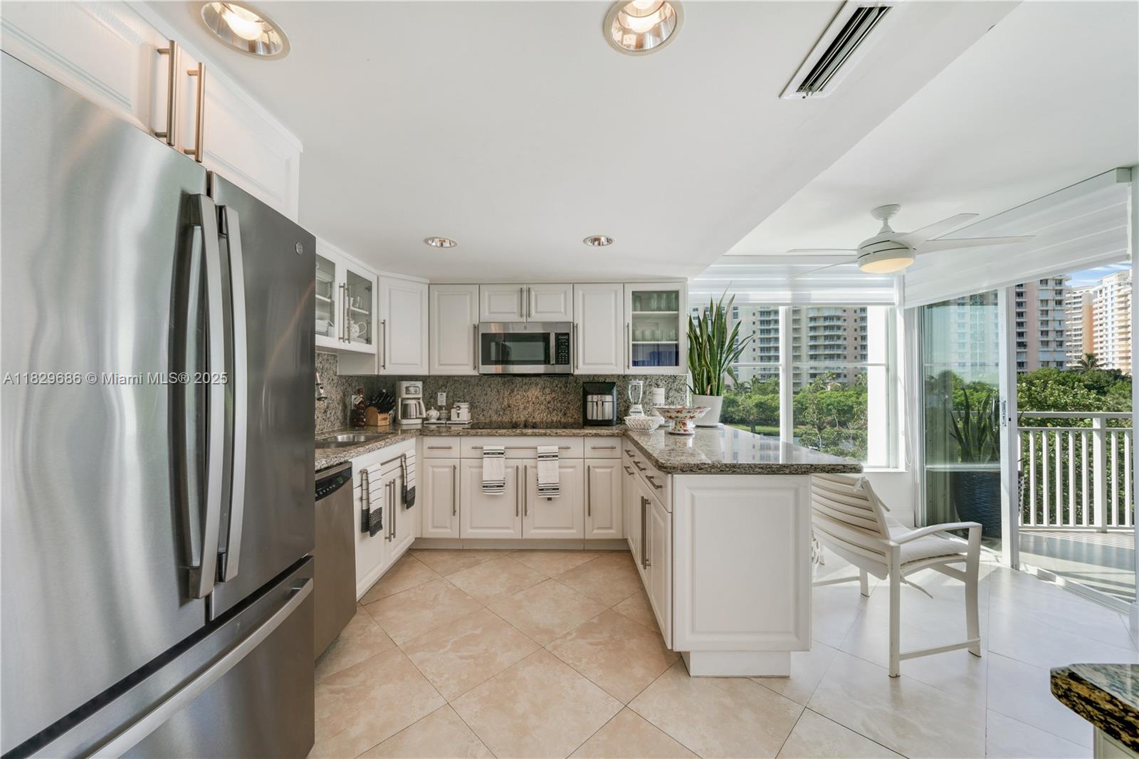 609 Ocean Drive, Unit 5H Key Biscayne, FL 33149 - Photo 21 of 28 a kitchen with stainless steel appliances granite countertop a refrigerator and a stove top oven