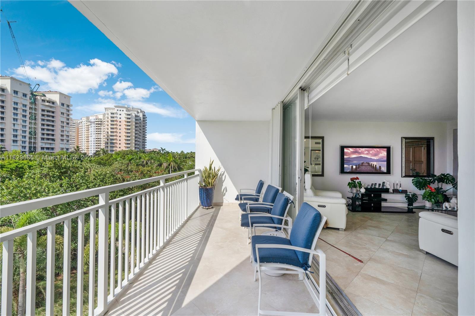 609 Ocean Drive, Unit 5H Key Biscayne, FL 33149 - Photo 3 of 28 a view of a balcony with chairs