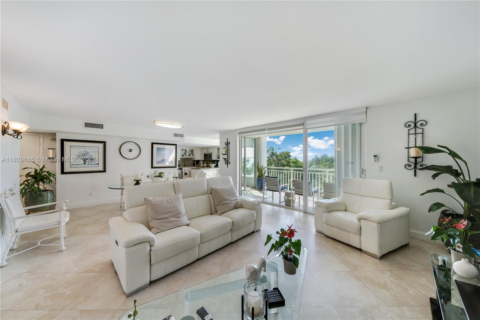 609 Ocean Drive, Unit 5H Key Biscayne, FL 33149 - Photo 6 of 28 a living room with furniture and a large window