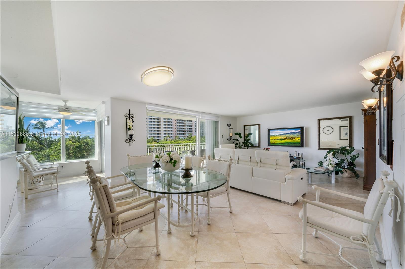 609 Ocean Drive, Unit 5H Key Biscayne, FL 33149 - Photo 8 of 28 a living room with furniture and a potted plant