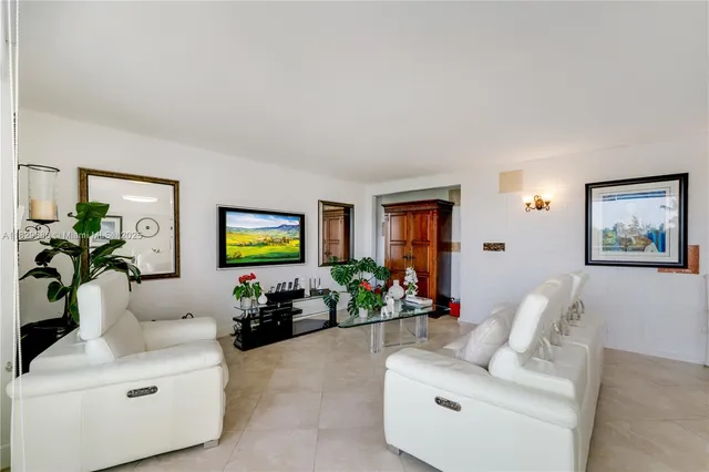 a living room with furniture flowerpot and a window
