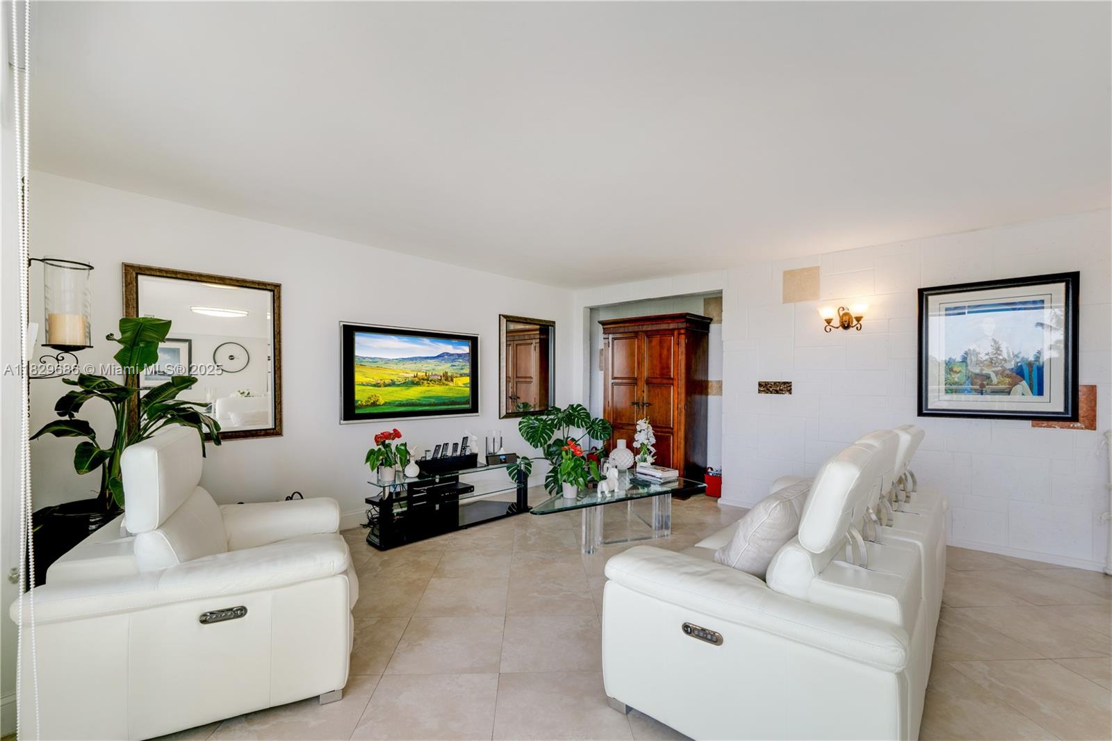 609 Ocean Drive, Unit 5H Key Biscayne, FL 33149 - Photo 9 of 28 a living room with furniture flowerpot and a window