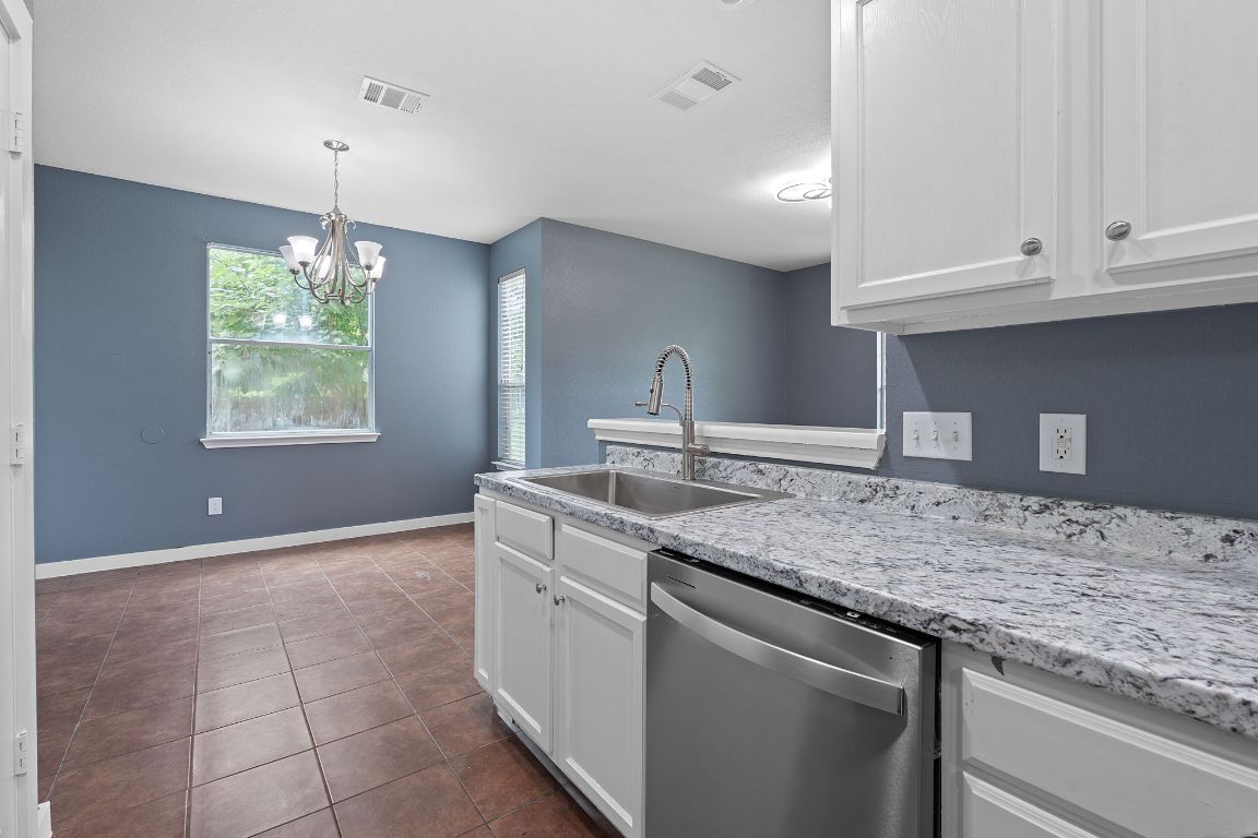 14517 Harris Ridge Boulevard, Unit B Pflugerville, TX 78660 - Photo 13 of 26 a kitchen with kitchen island granite countertop a sink and a stove