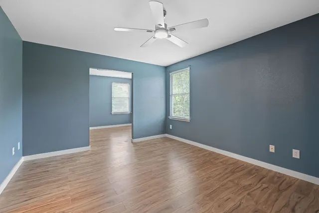 wooden floor in an empty room with a window