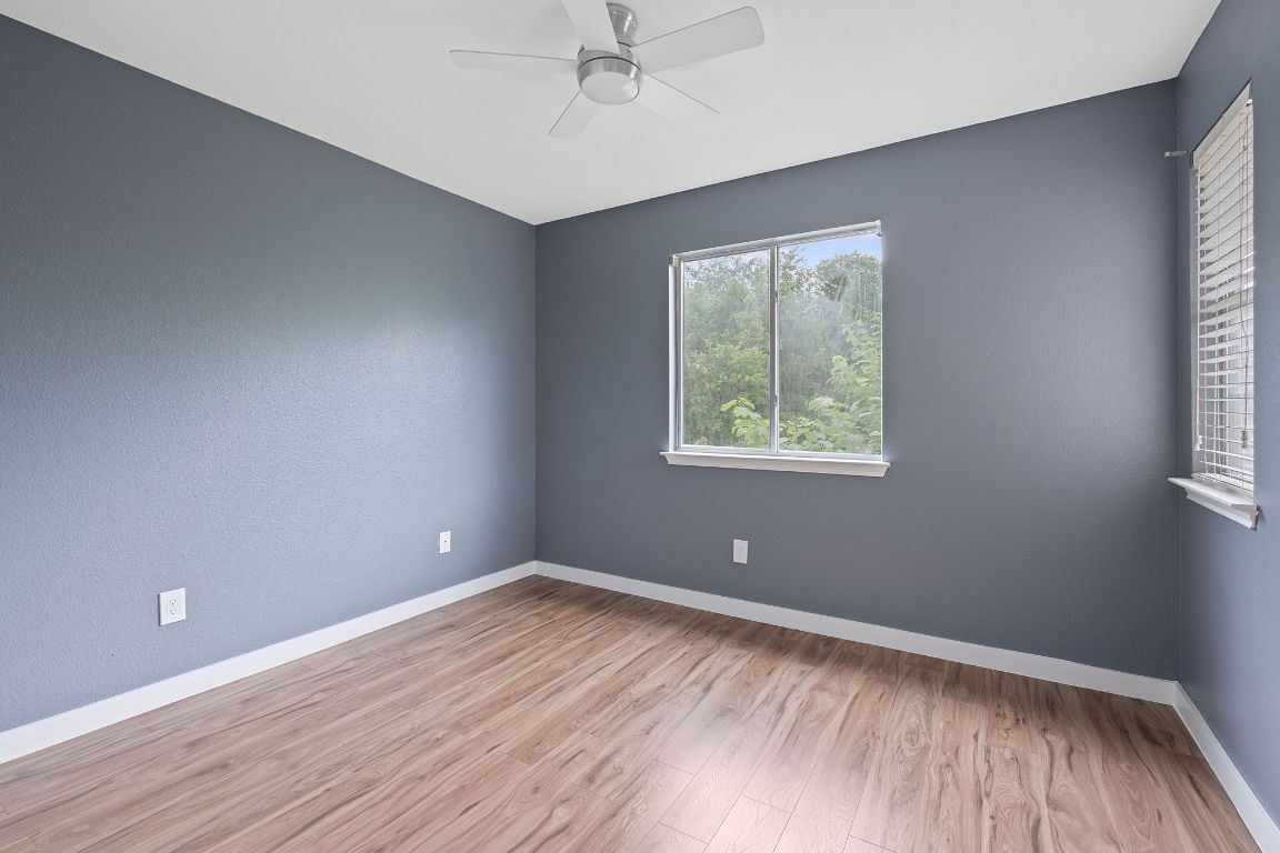 14517 Harris Ridge Boulevard, Unit B Pflugerville, TX 78660 - Photo 21 of 26 wooden floor in an empty room with a window