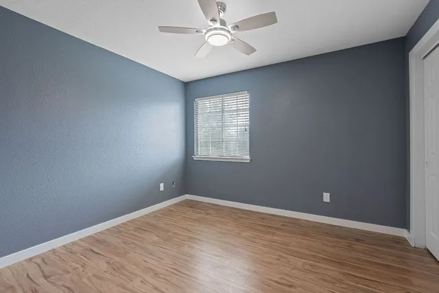wooden floor in an empty room with a window