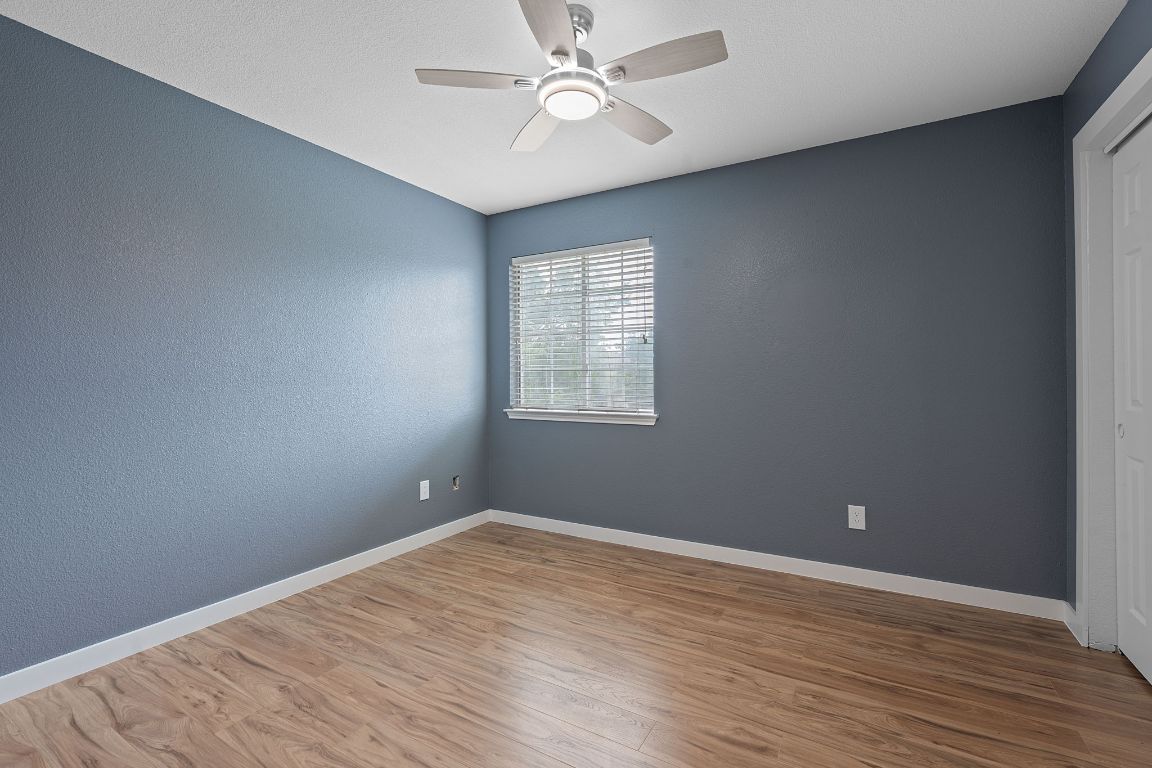 14517 Harris Ridge Boulevard, Unit B Pflugerville, TX 78660 - Photo 22 of 26 wooden floor in an empty room with a window