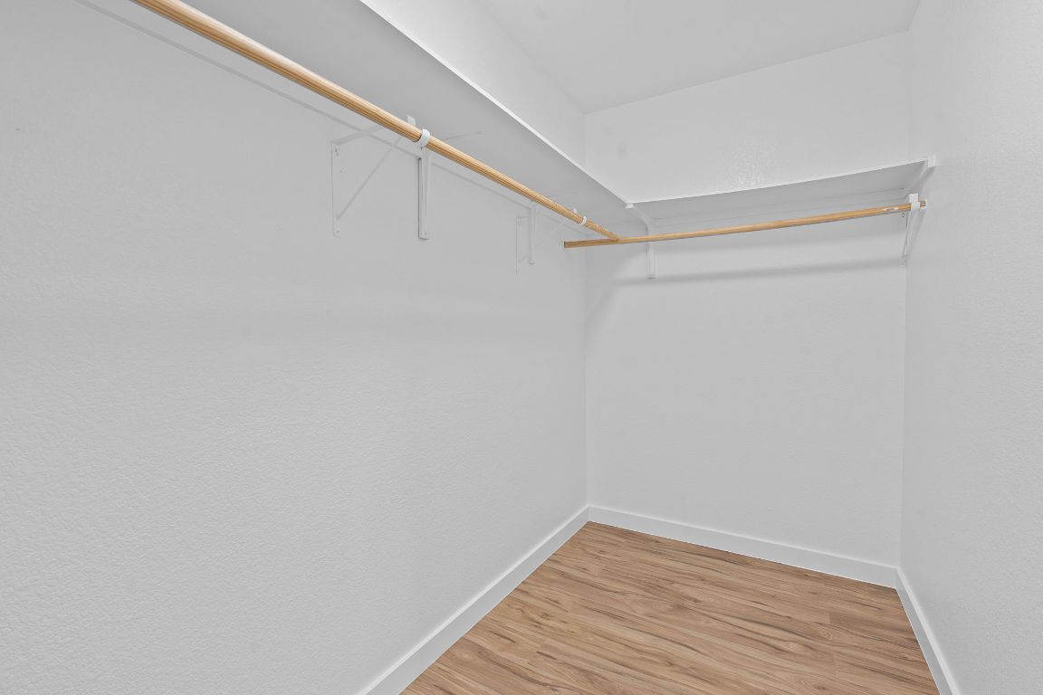 14517 Harris Ridge Boulevard, Unit B Pflugerville, TX 78660 - Photo 23 of 26 a view of a room with wooden floor