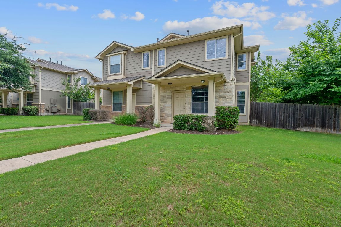 14517 Harris Ridge Boulevard, Unit B Pflugerville, TX 78660 - Photo 3 of 26 a front view of a house with a yard