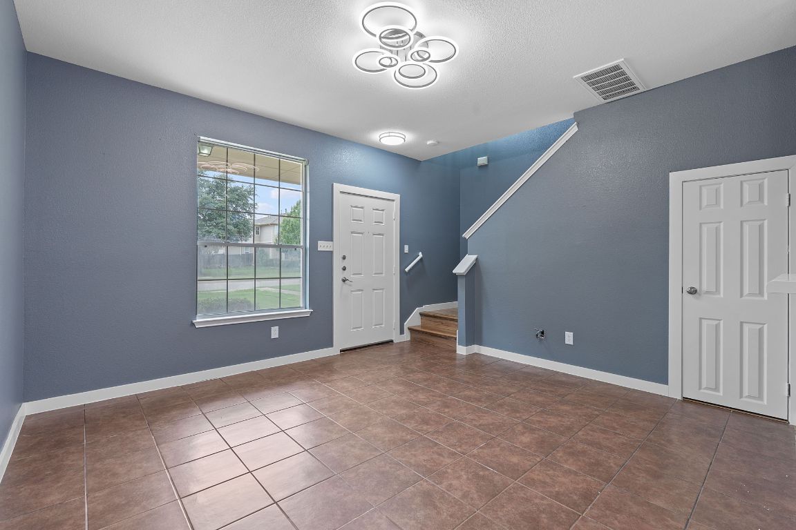 14517 Harris Ridge Boulevard, Unit B Pflugerville, TX 78660 - Photo 6 of 26 a view of an empty room with a window