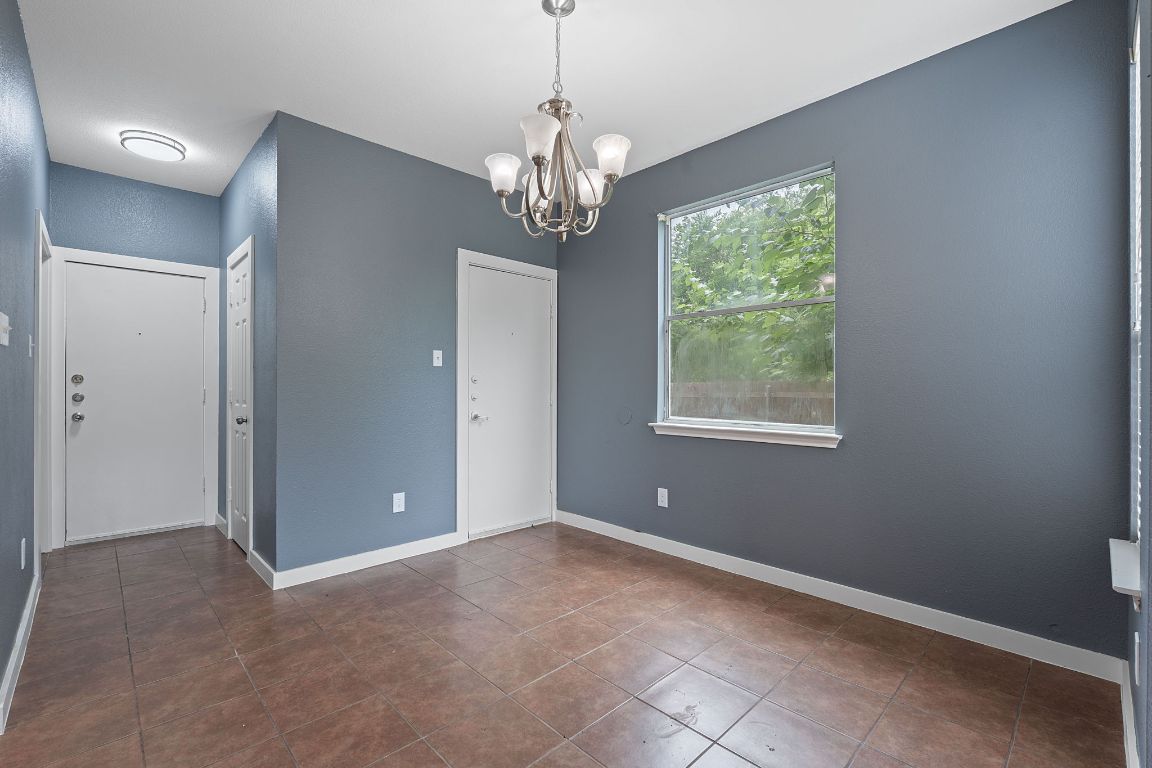 14517 Harris Ridge Boulevard, Unit B Pflugerville, TX 78660 - Photo 7 of 26 a view of an empty room with a window