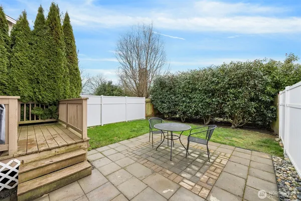 a view of a backyard with plants and a patio