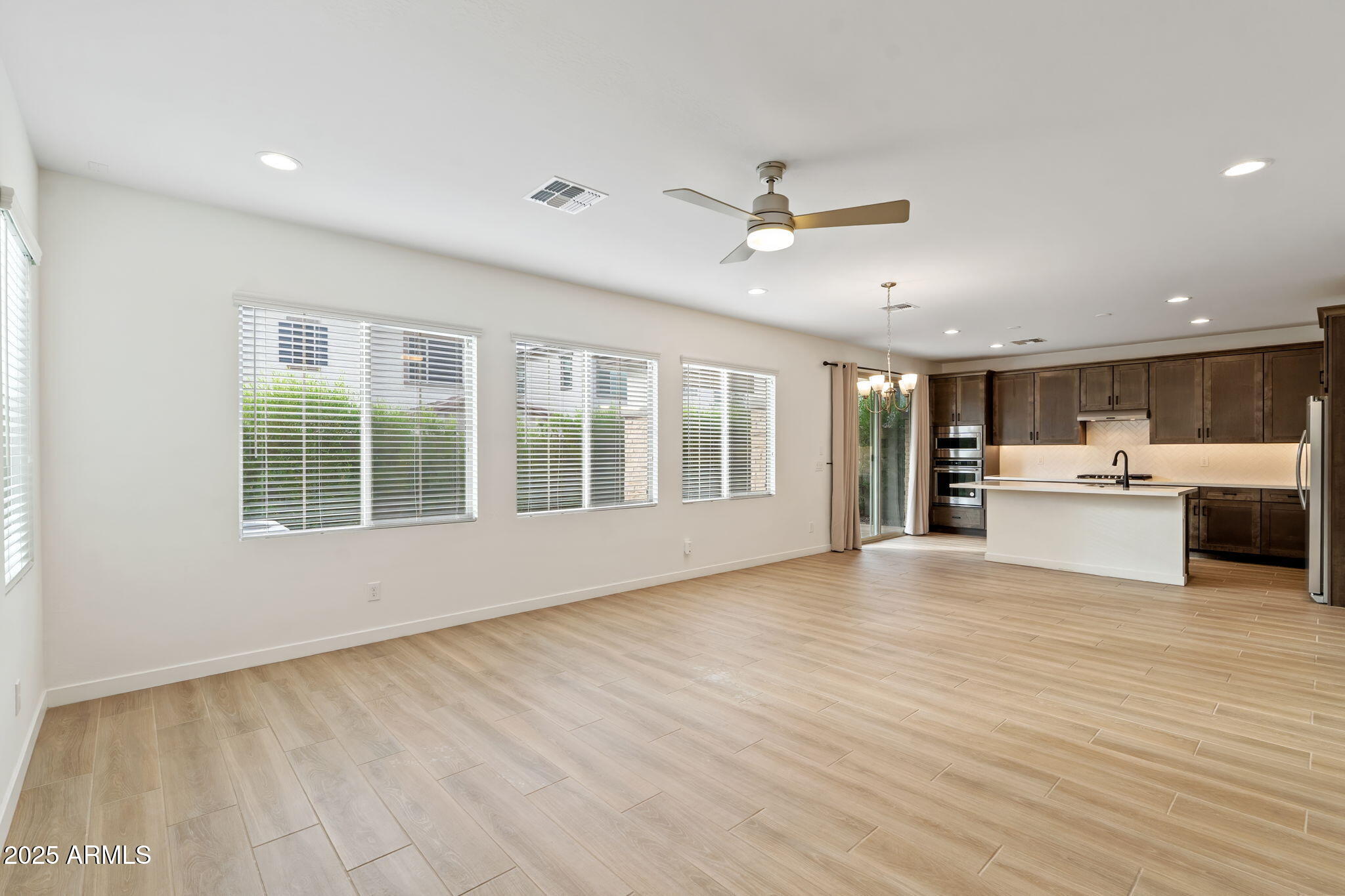 6428 North 17th Place Phoenix, AZ 85016 - Photo 12 of 48 a view of an empty room with kitchen and a window