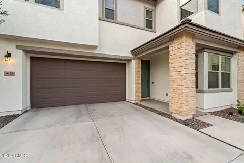 a front view of a house with parking area