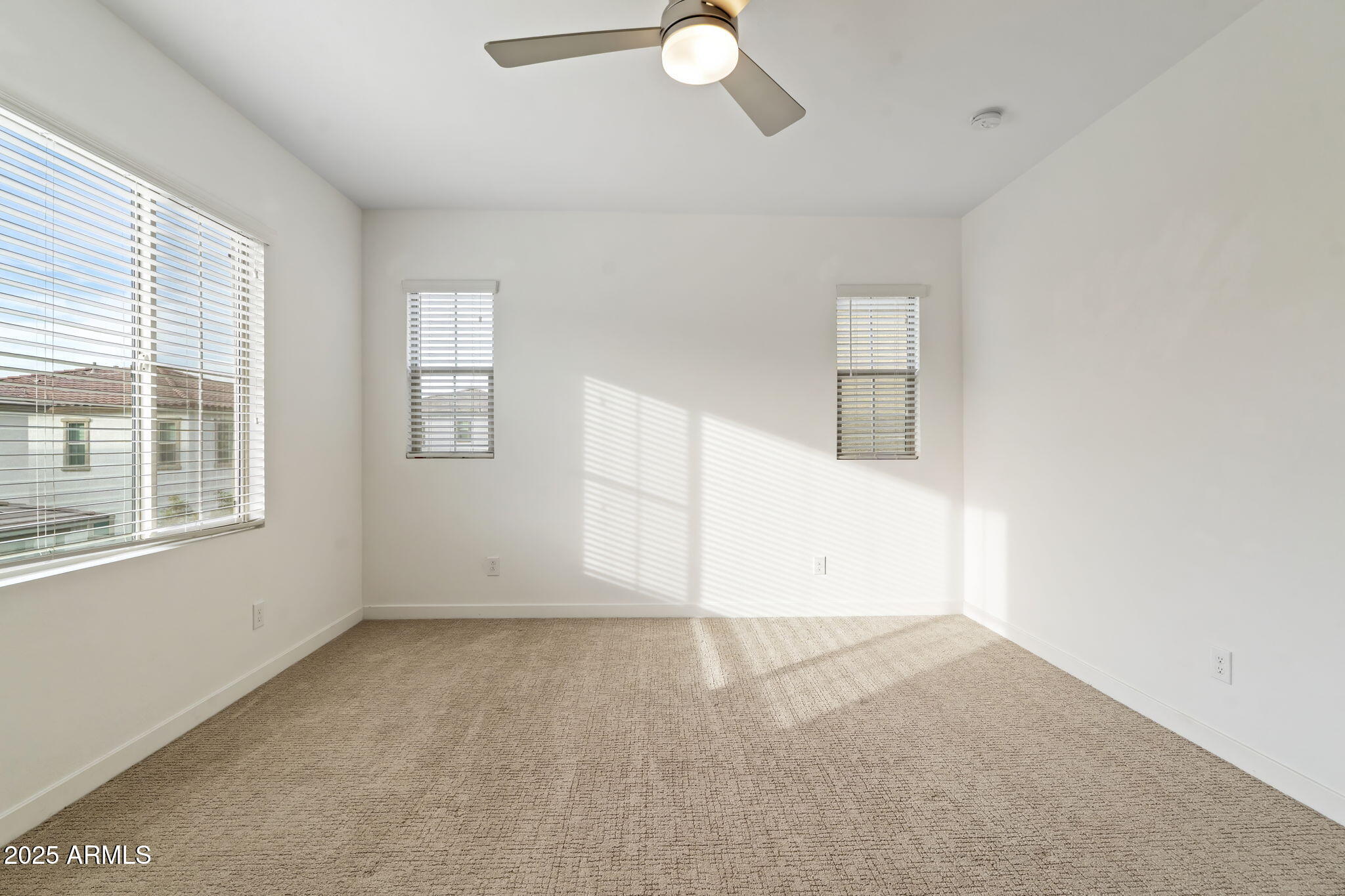 6428 North 17th Place Phoenix, AZ 85016 - Photo 27 of 48 an empty room with chandelier fan and windows