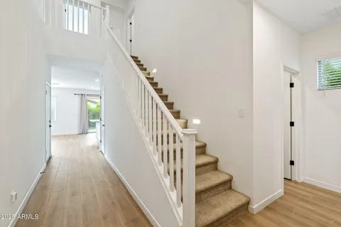 a view of a hallway with wooden floor and entryway