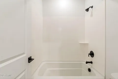 a view of empty room with window and ceiling fan