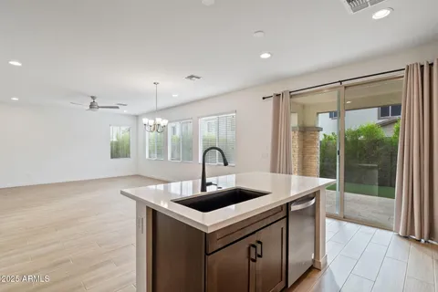a kitchen with a sink and a wooden floor