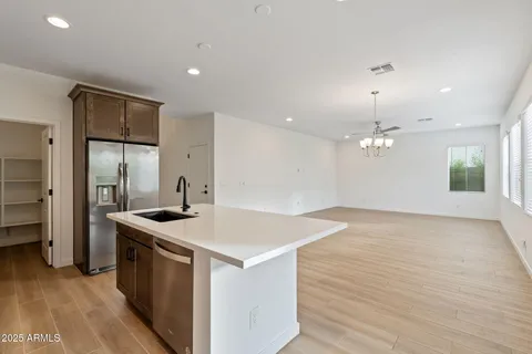 a kitchen that has a sink a stove and a refrigerator