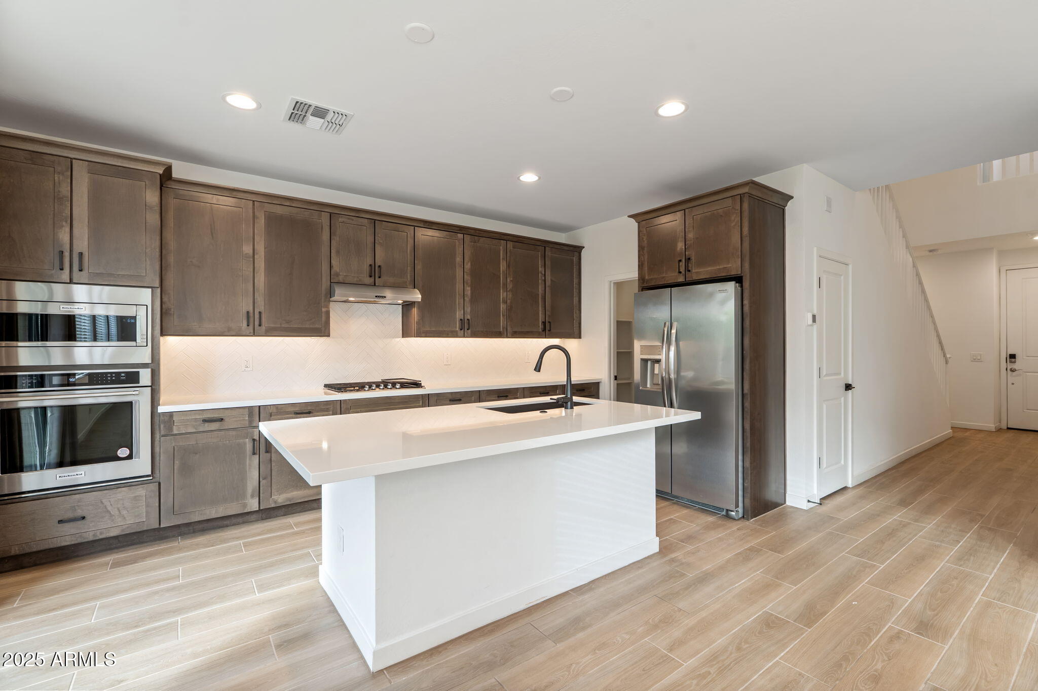 6428 North 17th Place Phoenix, AZ 85016 - Photo 10 of 48 a kitchen with stainless steel appliances granite countertop a stove a refrigerator and a microwave