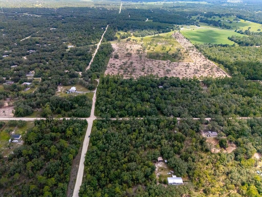 0 Northeast 110th Avenue Bronson, FL 32621 - Photo 5 of 11 an aerial view of residential houses with outdoor space and trees