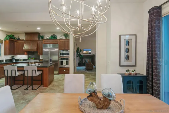 a living room with stainless steel appliances kitchen island granite countertop furniture and a view of kitchen