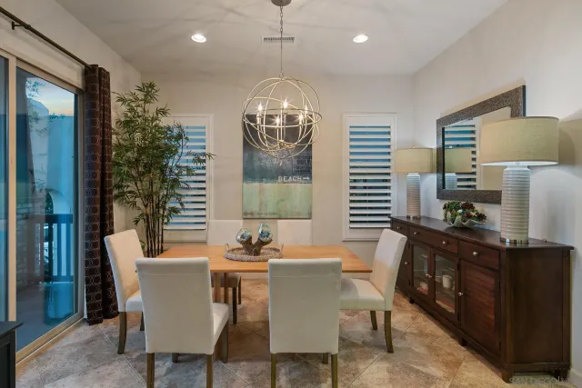 a dining room with furniture a chandelier and window