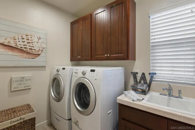 a bathroom with a sink a washer and dryer