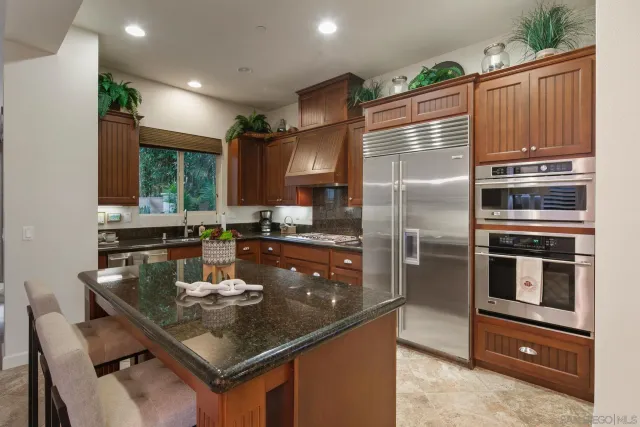 a kitchen with a refrigerator sink and stove