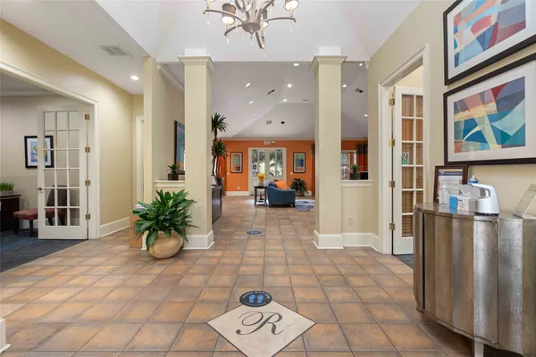 a lobby with furniture and a potted plant
