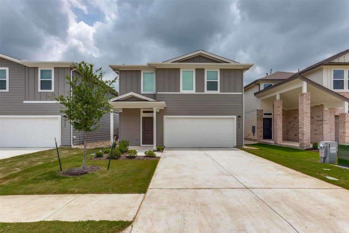 161 Jackman Drive Buda, TX 78610 - Photo 1 of 1 a front view of a house with a yard and garage
