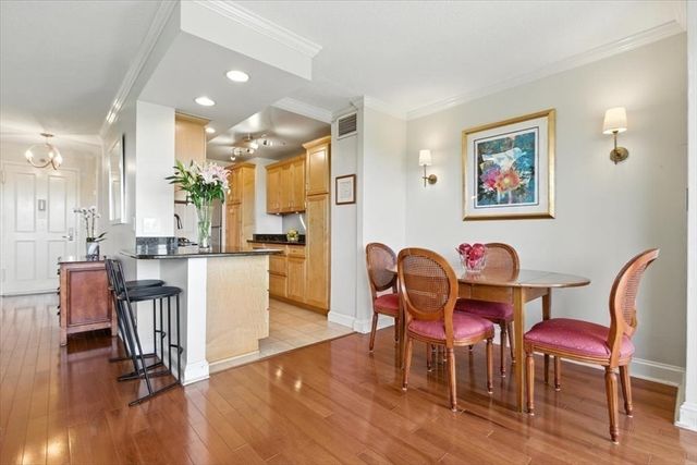 a dining room with furniture and wooden floor