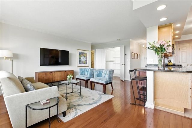 a living room with furniture wooden floor and a flat screen tv