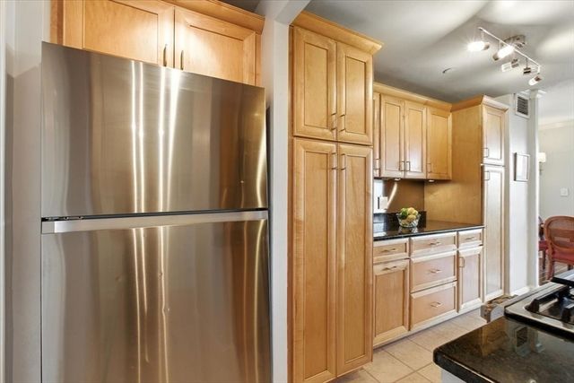 a kitchen with stainless steel appliances a refrigerator and cabinets