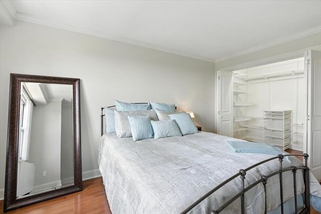 a bedroom with a bed and a mirror