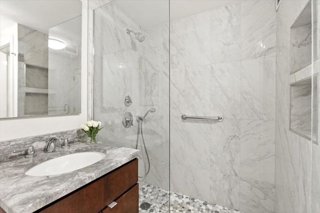a bathroom with a granite countertop sink and a mirror