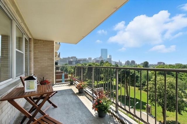 a view of a balcony with two chairs