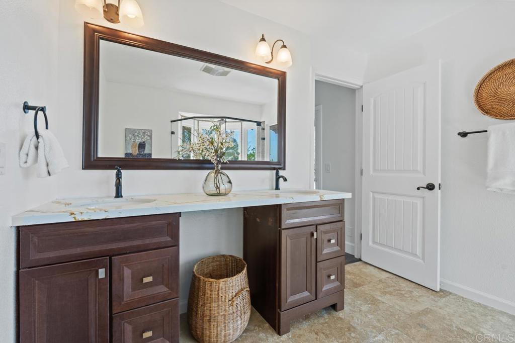 929 Cycad Drive San Marcos, CA 92078 - Photo 35 of 71 a bathroom with a sink and a mirror