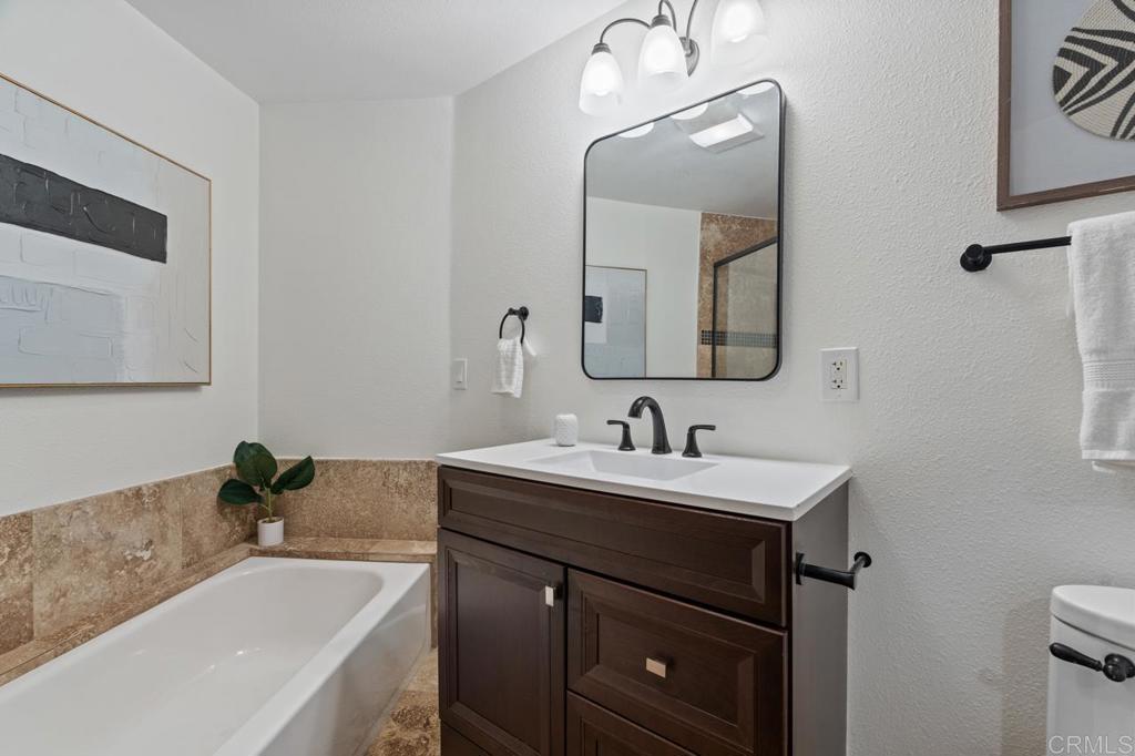 929 Cycad Drive San Marcos, CA 92078 - Photo 39 of 71 a bathroom with a tub sink and mirror