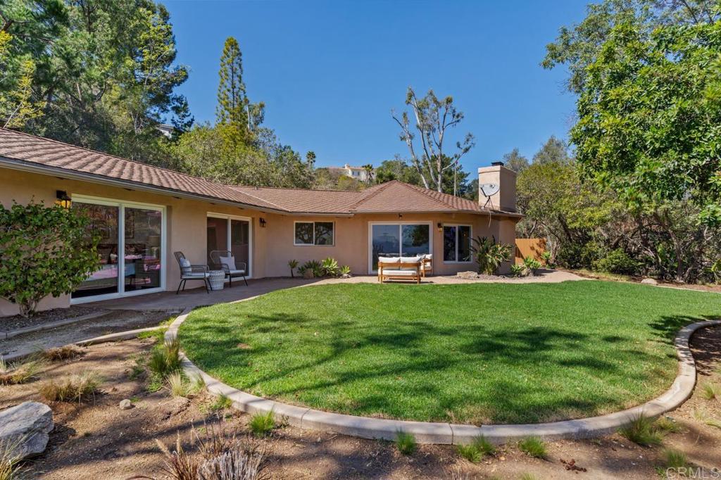 929 Cycad Drive San Marcos, CA 92078 - Photo 60 of 71 a front view of a house with a yard table and chairs