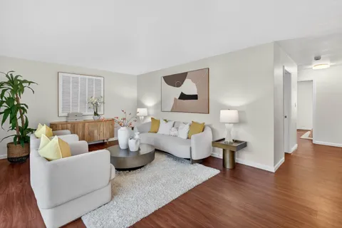 a living room with fireplace furniture and a wooden floor