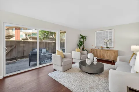 a living room with furniture and a floor to ceiling window